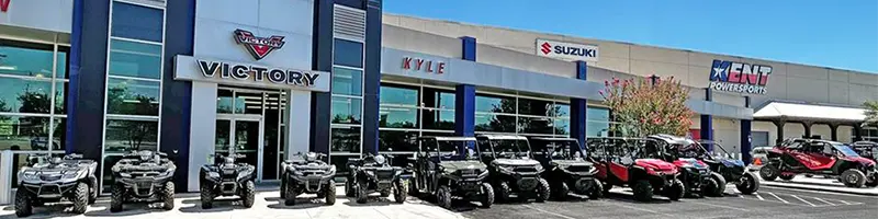 The clean and professional storefront of the Kent Powersports Austin dealership.