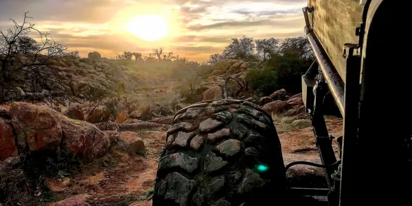 A UTV skillfully climbing a steep granite rock formation at Wolf Caves.